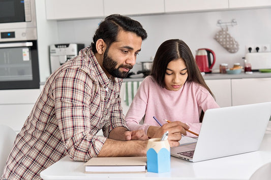 A dad helps his middle schooler daughter with school work. Representing the concept of homeschooling after elementary school.