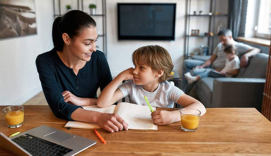 Mom helping child with dyslexia read and write