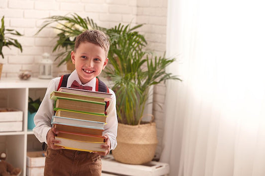 Young homeschooler carrying textbooks homeschool curriculum resources