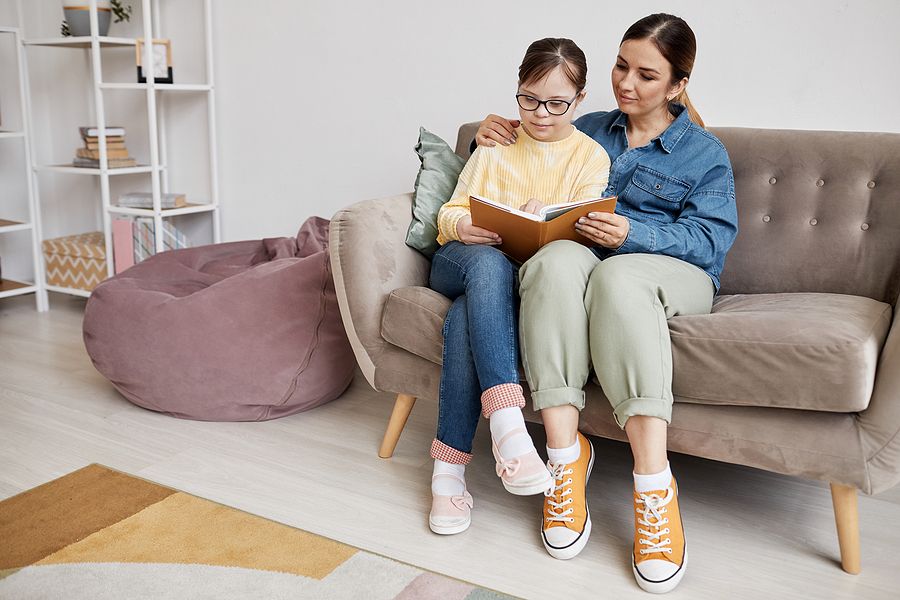 Homeschooling with autism for sensory-friendly environment mom reading with special needs daughter
