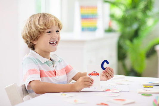 time to start homeschooling young child holding letters learning education